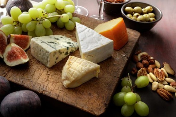 simple cheese board with assorted cheeses and suites