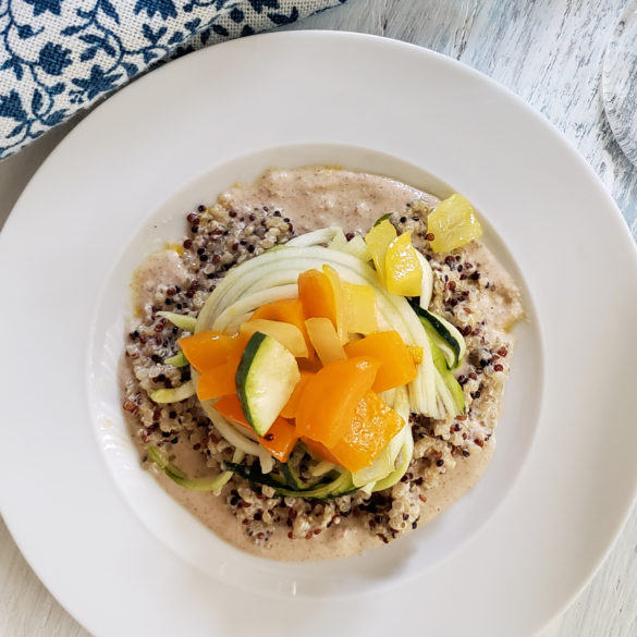 Sauteed bell peppers, zucchini, summer squash and onions in coconut oil over quinoa with a savory nut based sauce.