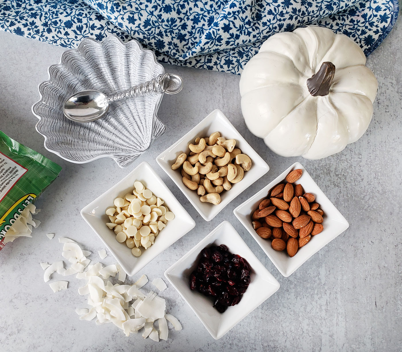 Healthy fall party mix ingredients, white chocolate chips, dried cranberries, almonds, cashews, coconut flakes