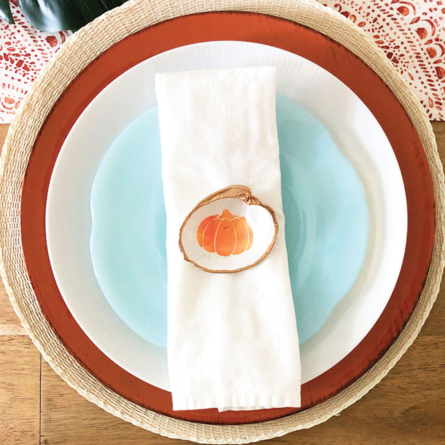 Palm Beach Thanksgiving tablescape with decoupage pumpkin shell and blue plate