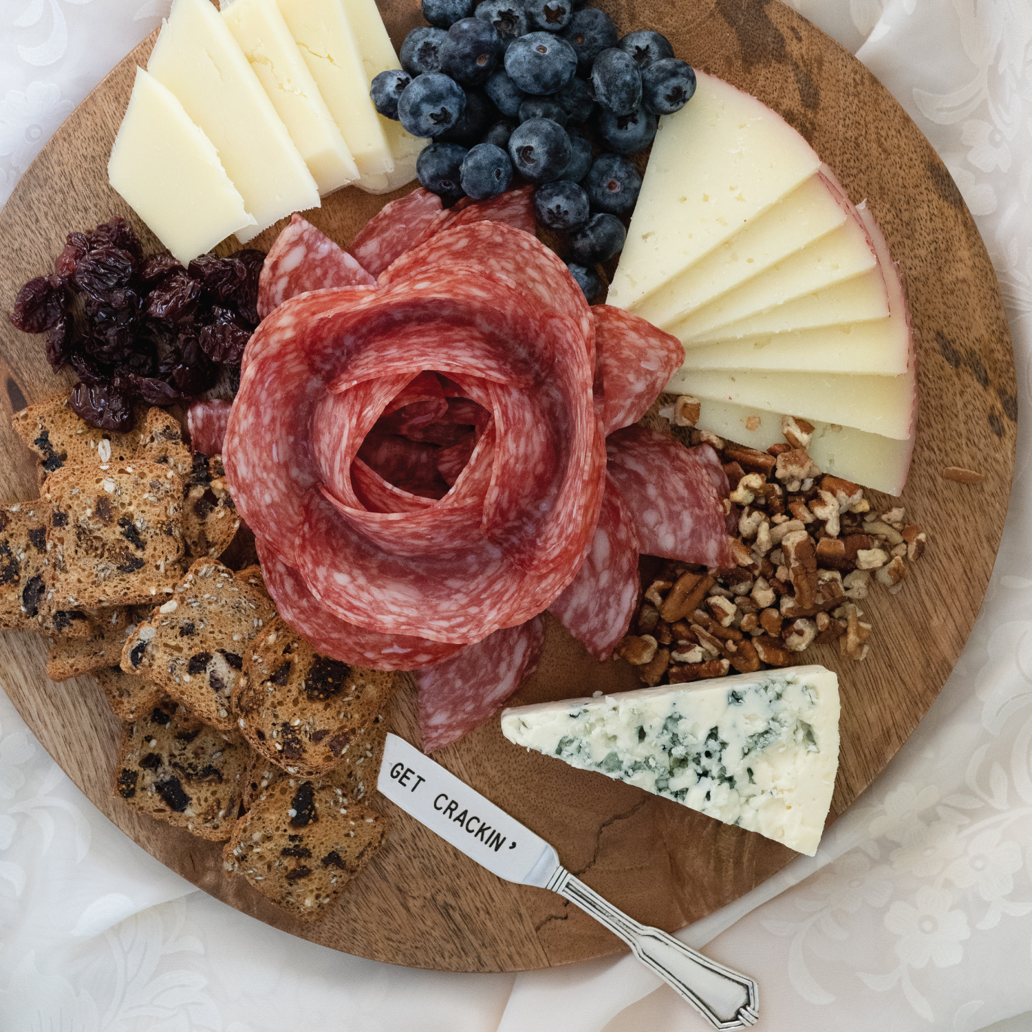 how to make a charcuterie grazing board for 2. Add in a pretty salami flower.