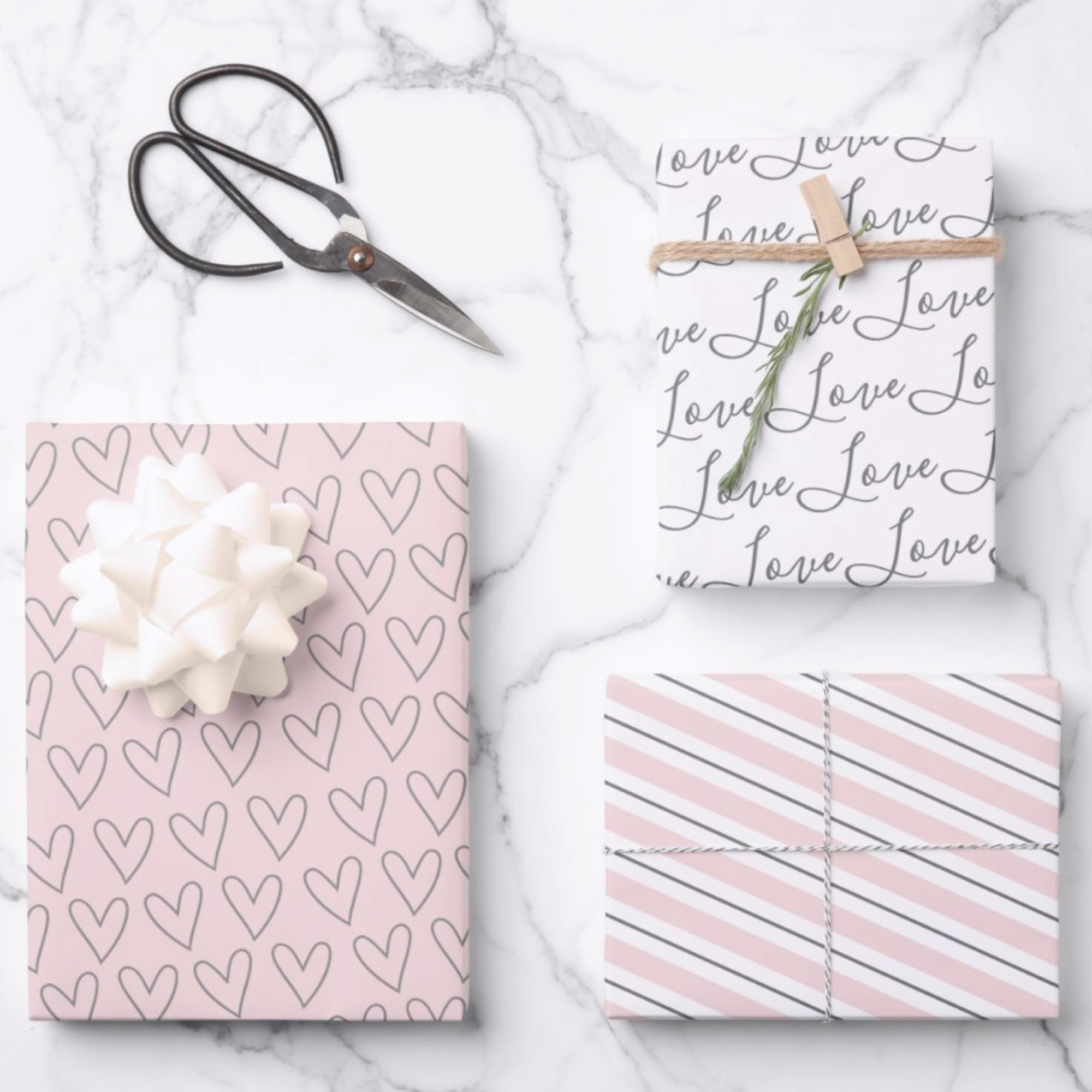 Valentines theme wrapping paper sheets. Set of 3blush pink and grey hand drawn hearts with the word love in a script typography and stripes.