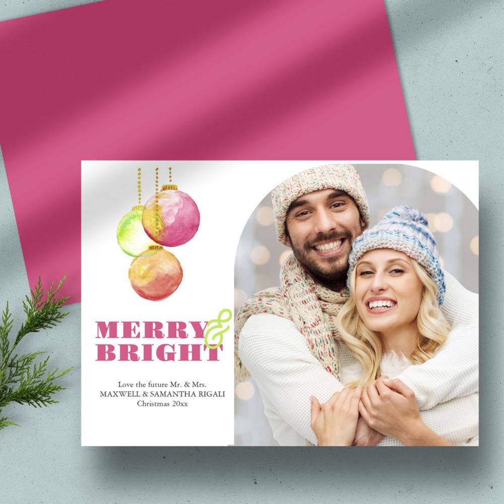 Merry & Bright Modern Photo Christmas Cards. This unique Christmas card design features my original watercolor holiday ornaments in shades of pinks, greens and red. The words "Merry & Bright" are set in a traditional serif typeface in a complimentary color on a simple white background. Customize with your wording and family, couples or pet photo in a modern arch design. The card reverses to a complimentary pinkish red color. Order as many as little or as many as you like.