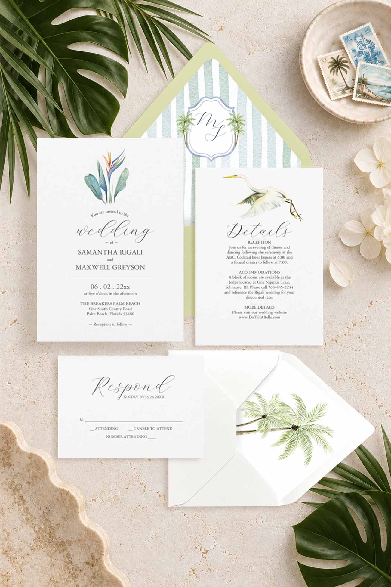 Tropical watercolor palm tree wedding invitation suite with bird-of-paradise flower, green envelopes, striped monogram liner, RSVP and details cards.