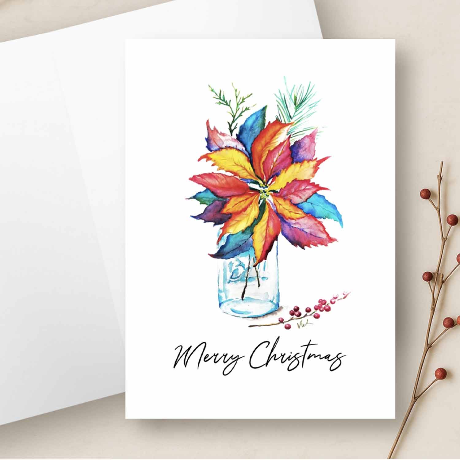 Colorful watercolor poinsettia Christmas card in a rustic glass canning jar with “Merry Christmas” in script, blank inside for personal messages or holiday cards printable. Design by Do Tell A Belle.