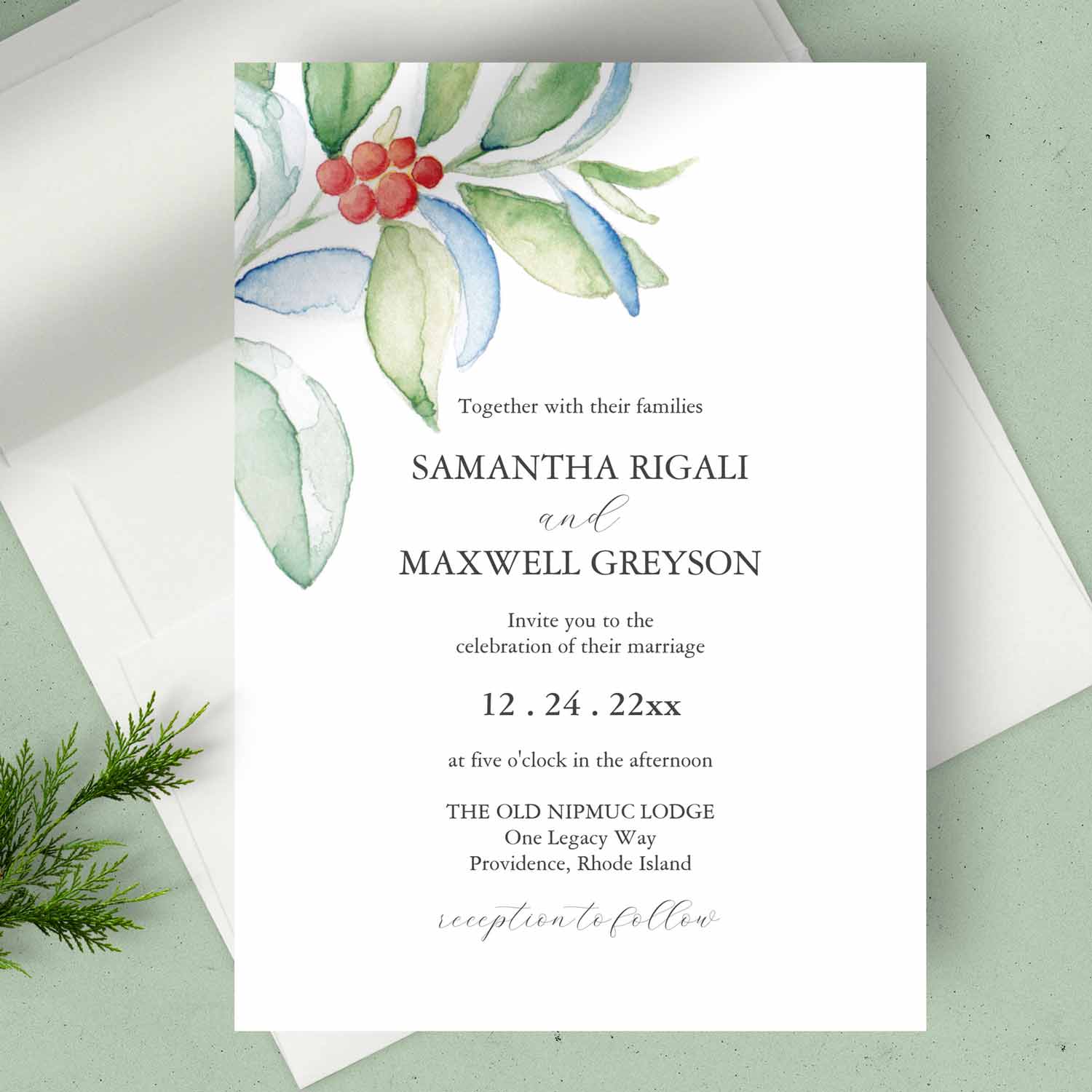 Winter wedding invitation features watercolor red berries and greenery art by Victoria Grigaliunas of Do Tell A Belle