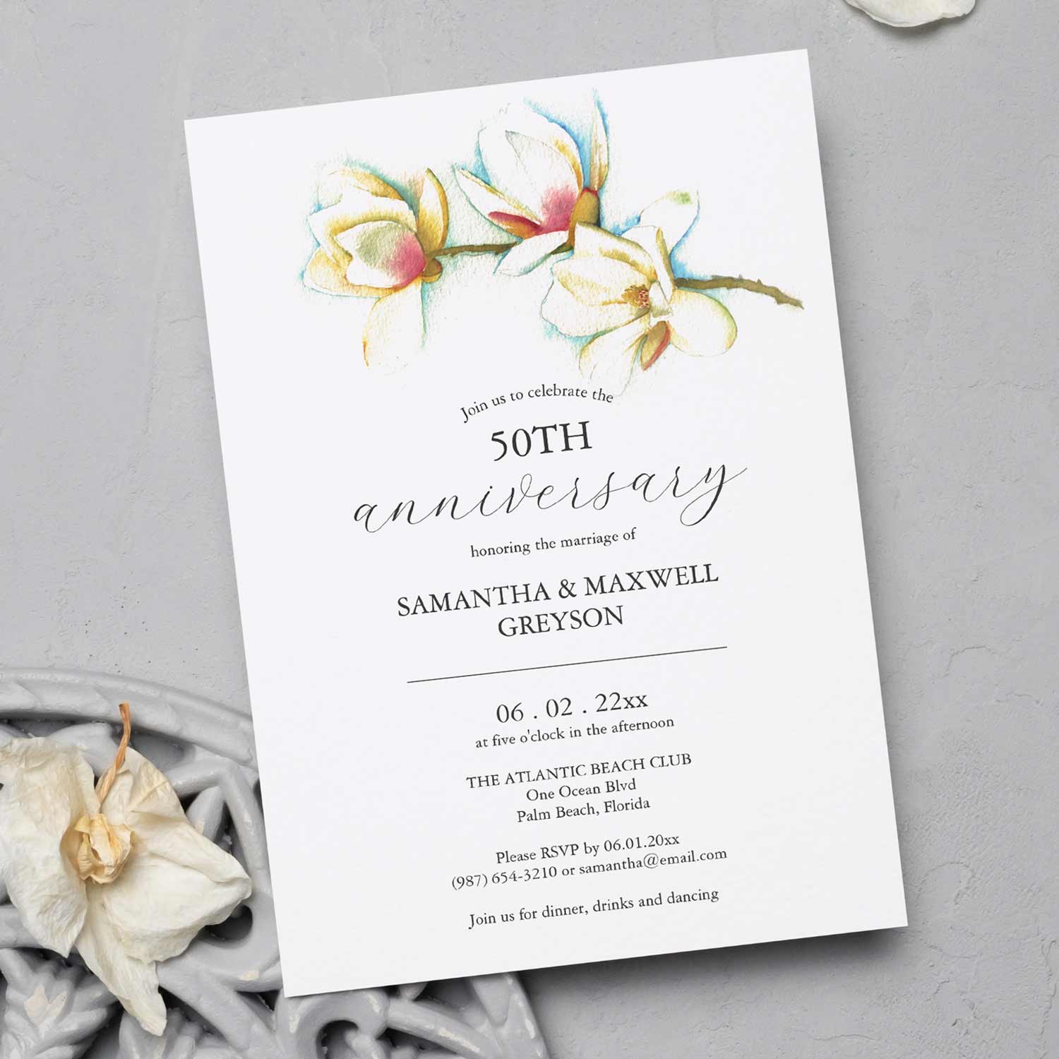 50th wedding anniversary invitations feature a top boarder of watercolor white magnolia flowers by Victoria Grigaliunas of Do Tell A Belle. Click to shop this invitation.