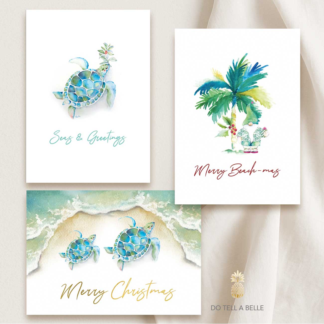 Set of three beach Christmas cards featuring hand-painted watercolor art by Victoria of Do Tell A Belle: a sea turtle with turquoise ocean hues, a tropical palm tree with the words ‘Merry Beach-mas,’ and a festive sea turtle and shoreline design.
