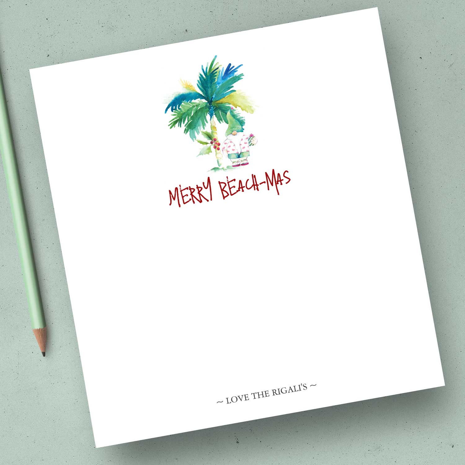 Christmas notepads feature watercolor palm tree and Santa in shorts with the words "Merry Beach-mas". Unique art by Victoria Grigaliunas of Do Tell A Belle. Click to shop.