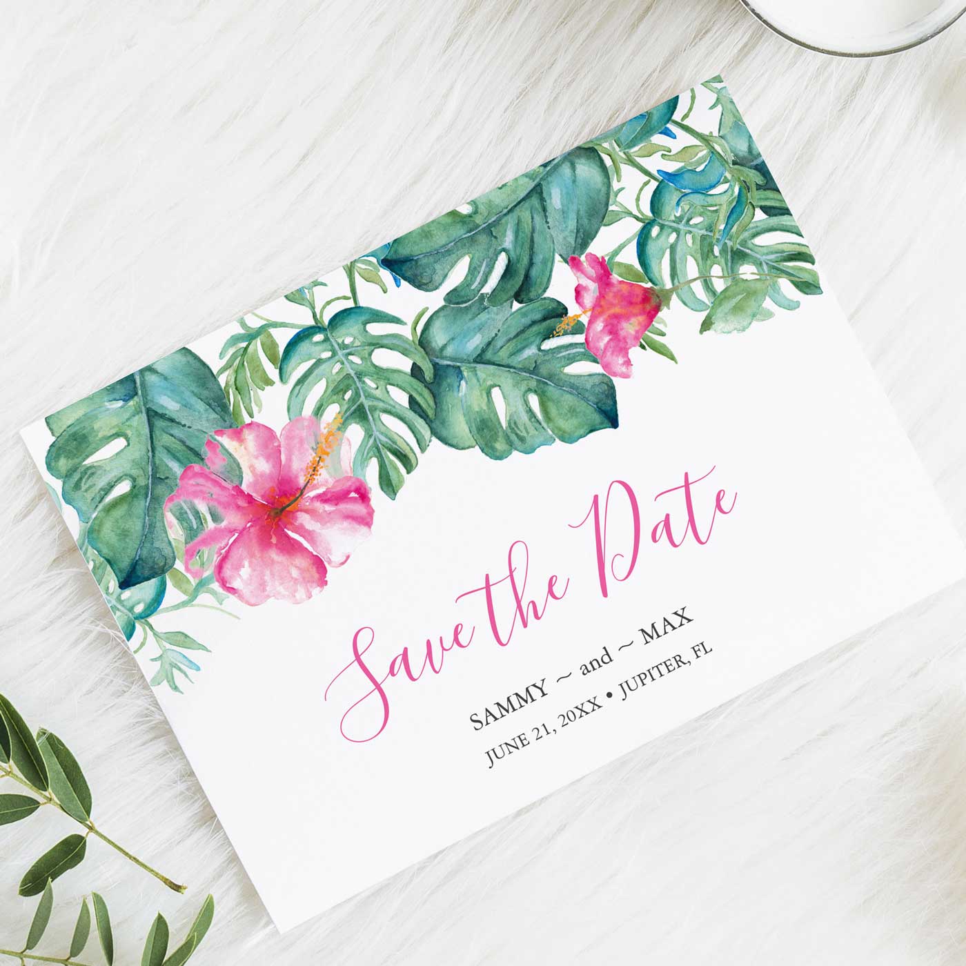 Tropical destination wedding save the date card feature watercolor pink hibiscus flowers and palm leaves. Click the image to see the full wedding invitation teme. 