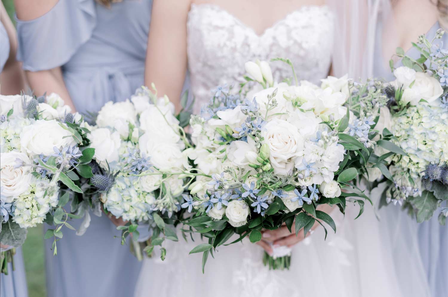 Dusty blue wedding ideas feature a beautiful bouquet of blue and white florals