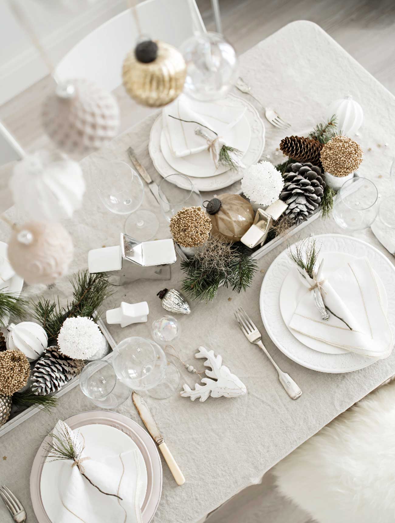 Winter bridal shower theme tablescape in white, silver and green with rustic elements