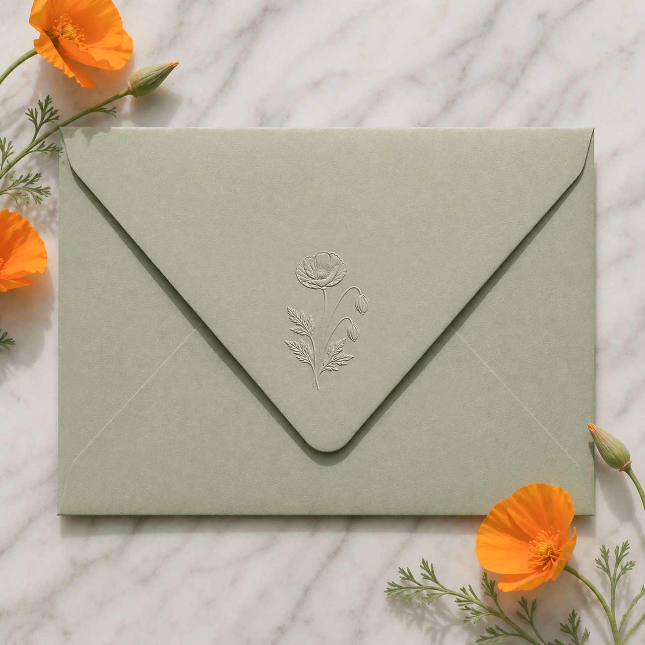 Sage green a7 envelope with embossed floral design.