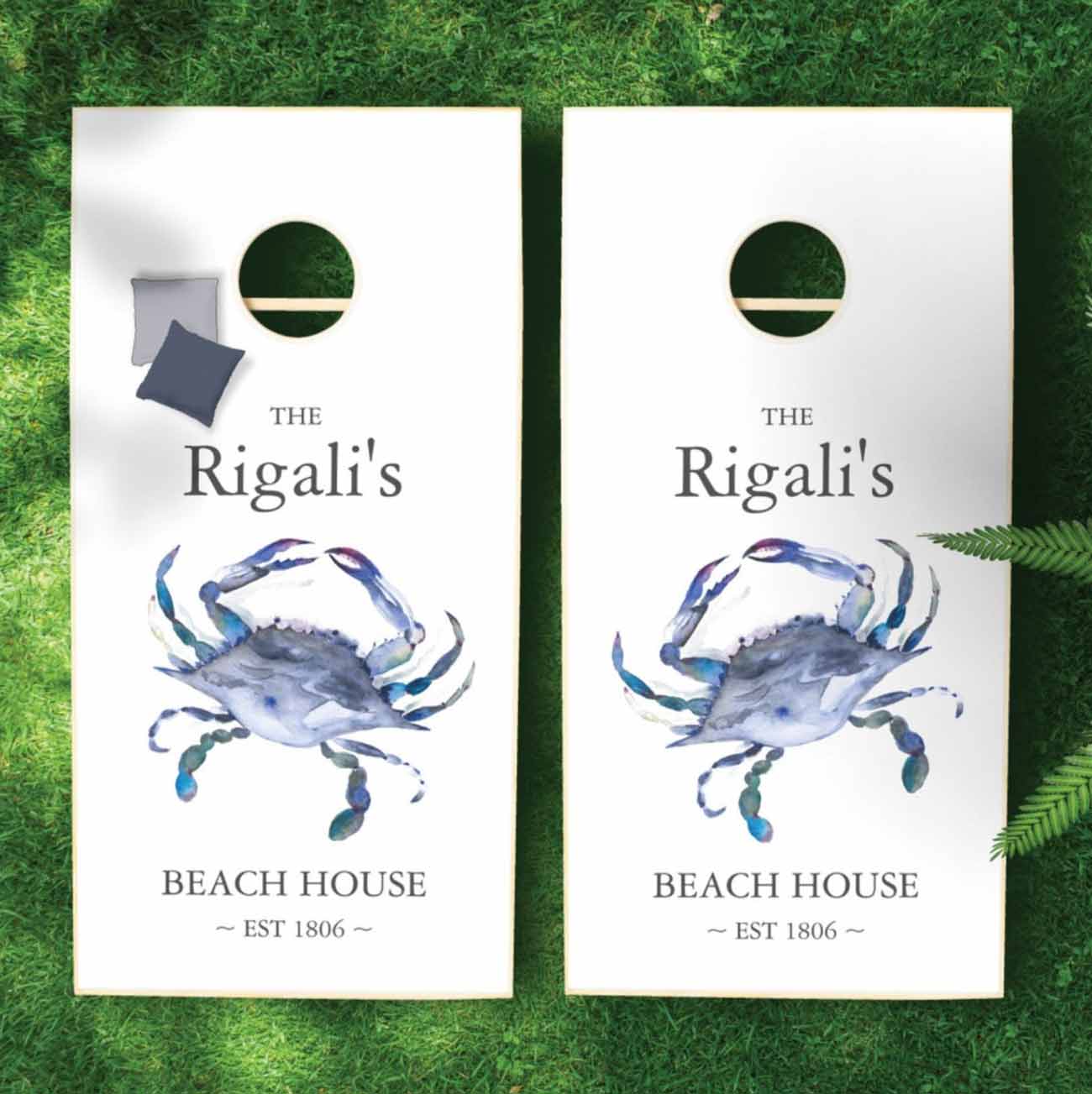 beach theme bridal shower games features a custom cornhole set with blue crab design.