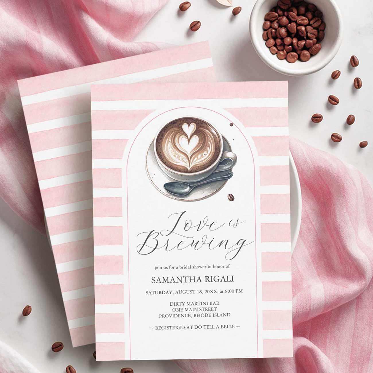 Pink coffee bridal shower theme invitations featuring watercolor pink stripes, a latte with heart-shaped foam, and the words “Love Is Brewing,” customizable with your text and available as printed cards or a printable download.