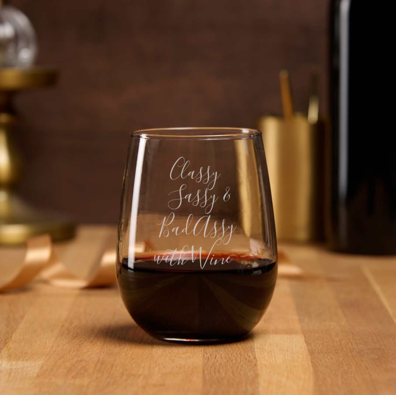 Funny wine glasses feature the words "classy, sassy and bady assy with wine".