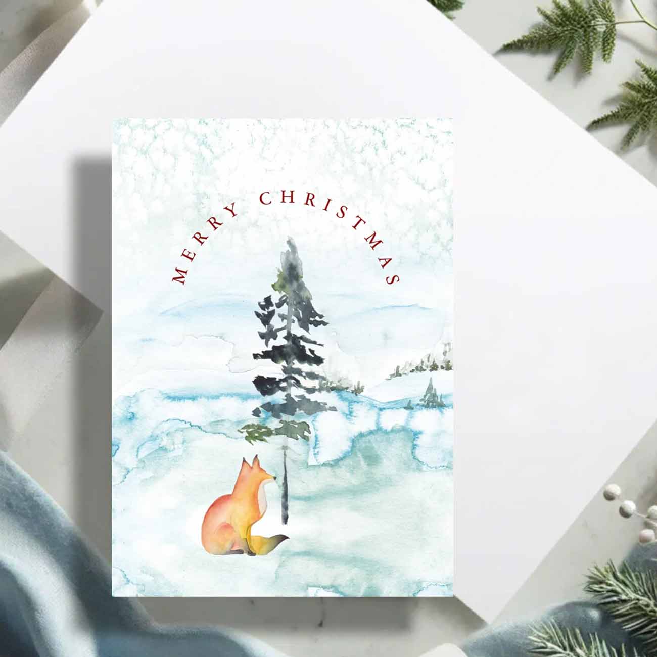 Flat lay of fox xmas cards by Victoria Grigaliunas of Do Tell A Belle a woman owned small business. The card is blank inside.