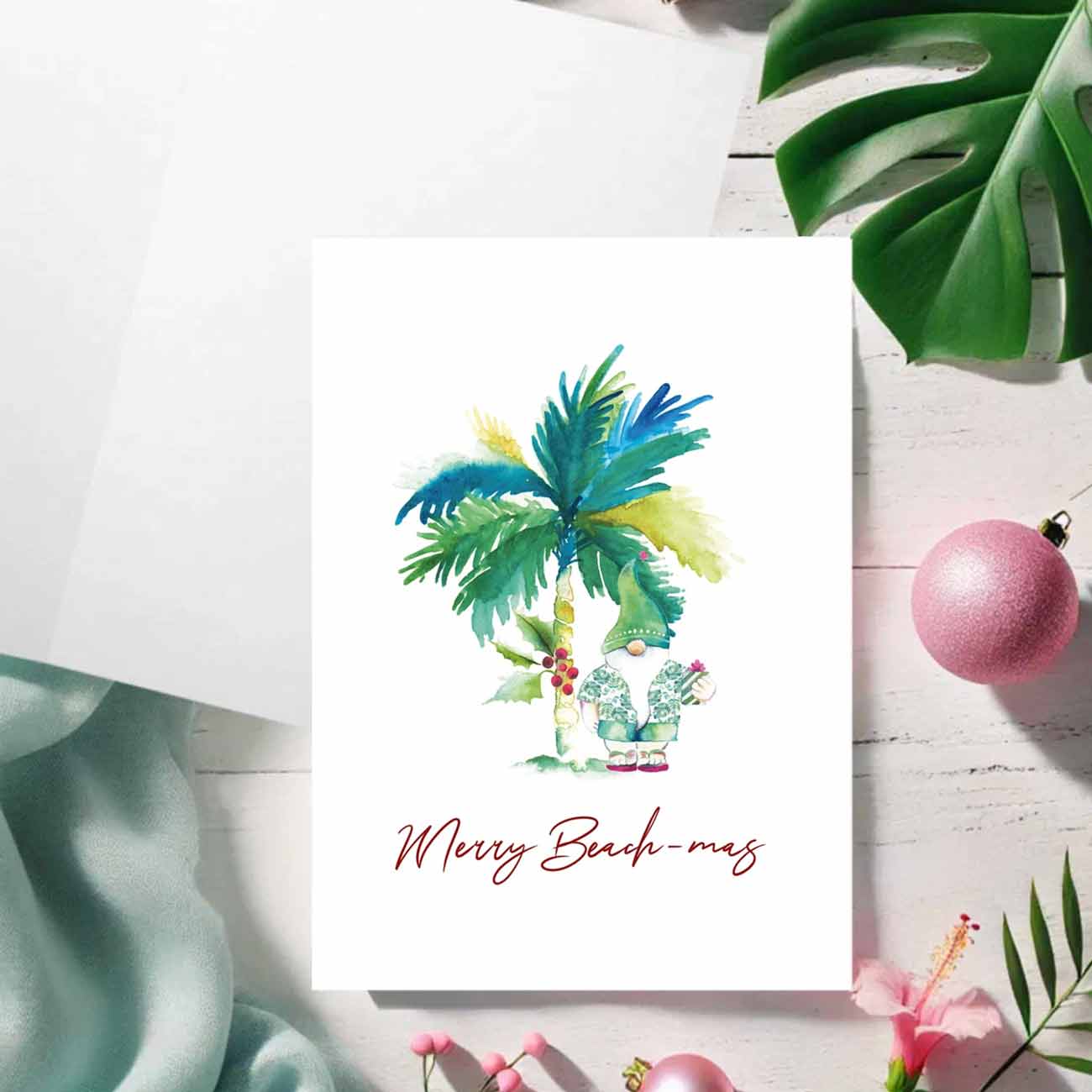 Flat lay of tropical Christmas cards by Watercolor artist Victoria Grigaliunas of Do Tell A Belle a woman owned small business in South Florida