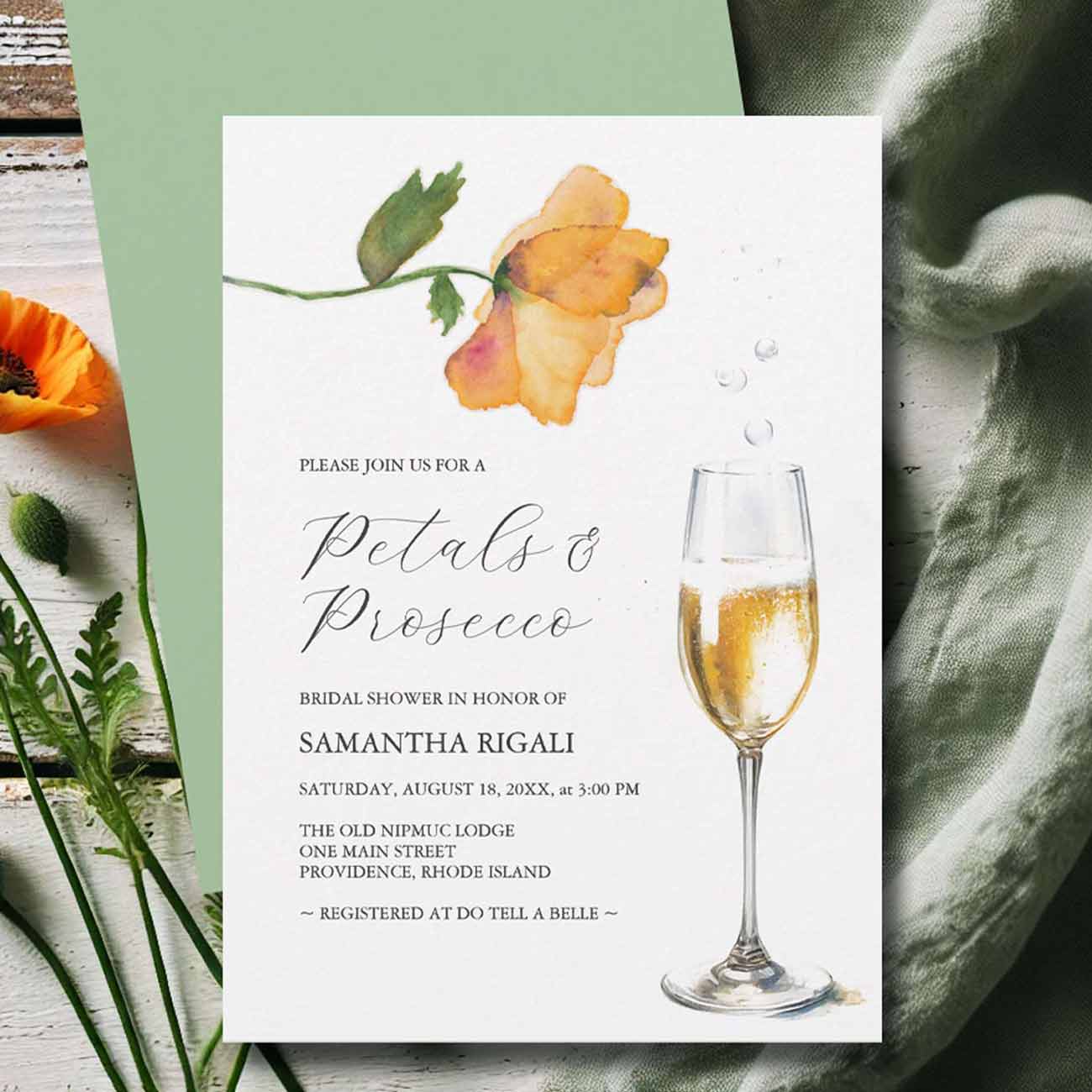 Flat lay of a custom bridal shower invitation designed with hand painted floral art by Florida watercolor artist Victoria Grigaliunas of Do Tell A Belle