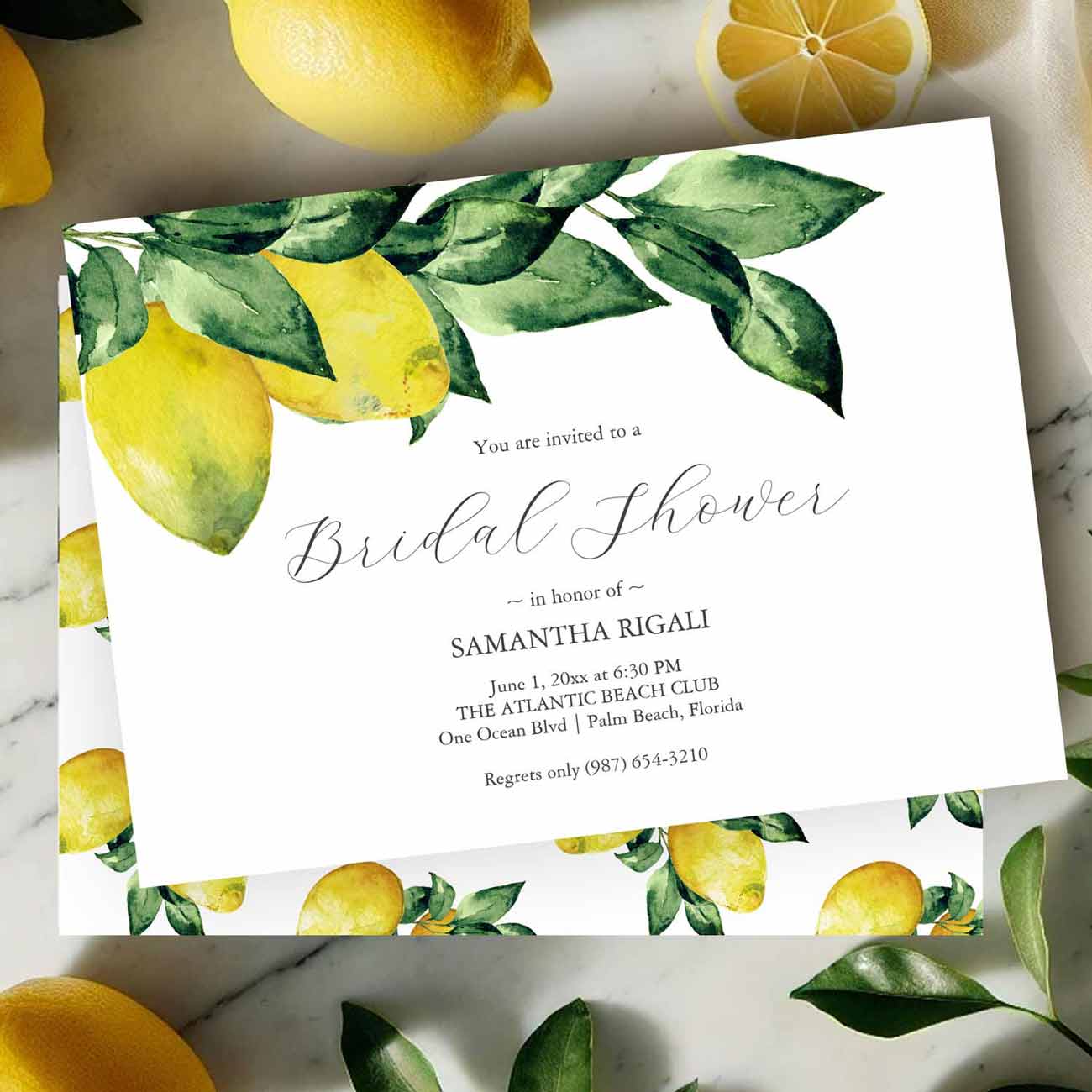 Flat lay of a custom bridal shower invitation designed with hand painted lemons by Florida watercolor artist Victoria Grigaliunas of Do Tell A Belle
