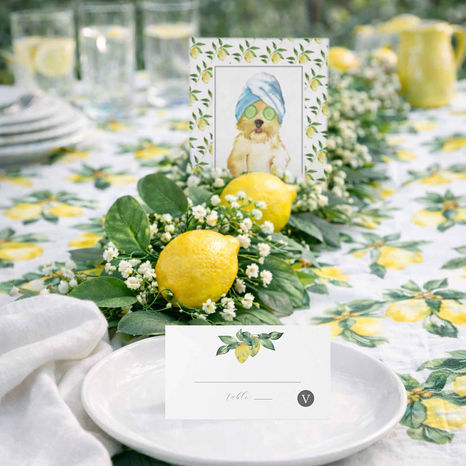 how to make a DIY lemon garland for a party using lemons, greenery, and flowers for a lemon bridal shower theme