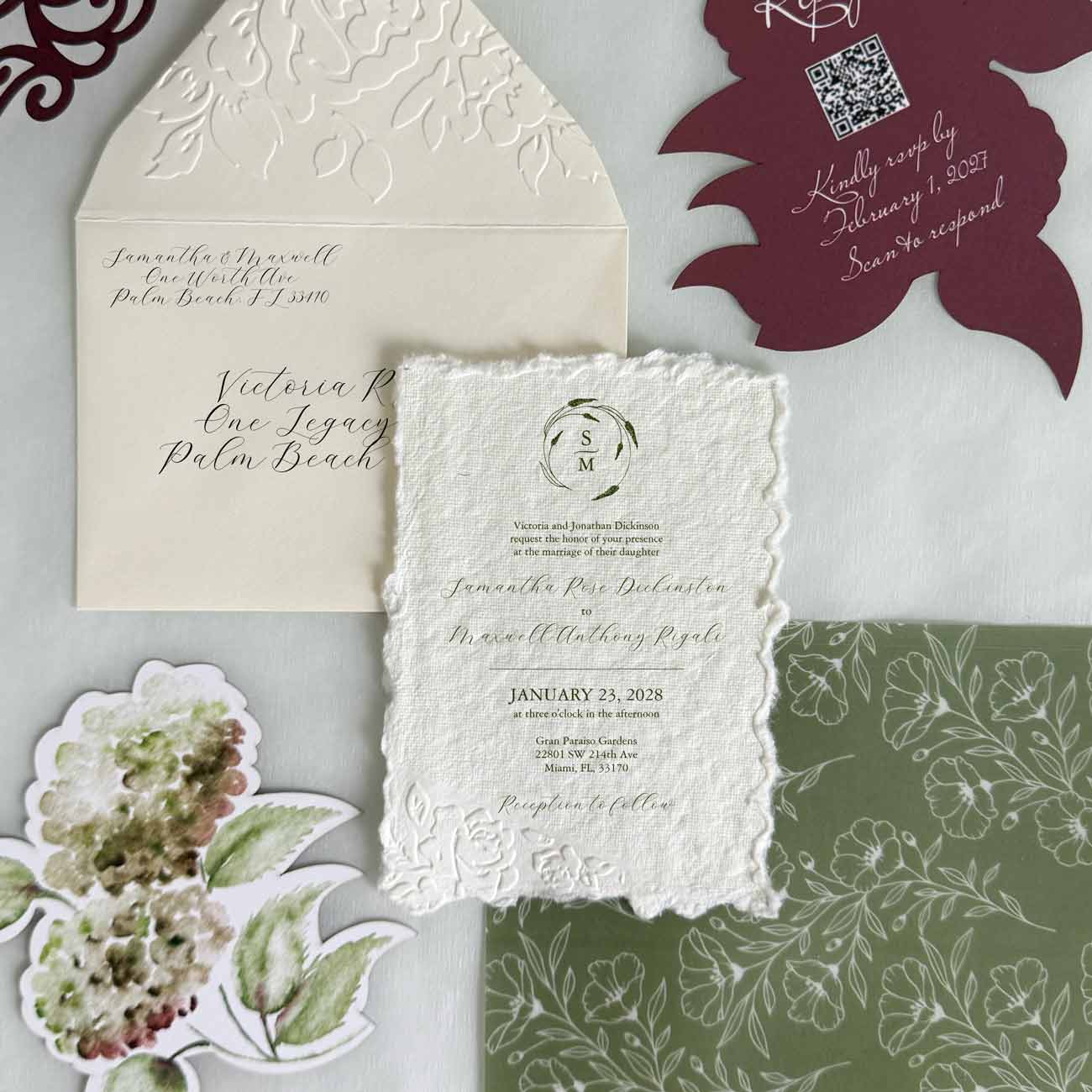 Luxury embossed wedding invitation suite with deckled edge paper, floral embossed envelope, green vellum wrap, watercolor hydrangea RSVP card, and formal wedding invitation wording in burgundy, green, and creamy white by Do Tell A Belle.
