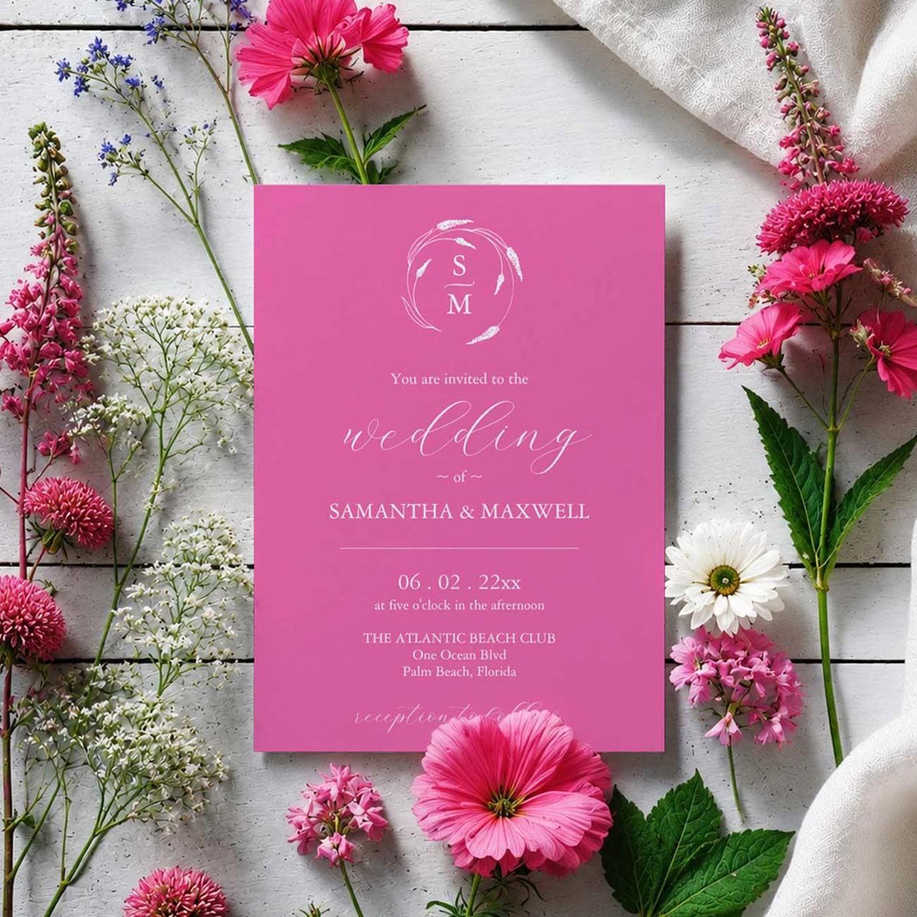 Vibrant pink wedding invitation featuring a floral monogram with hand-drawn flowers encircling the bride and groom's initials.