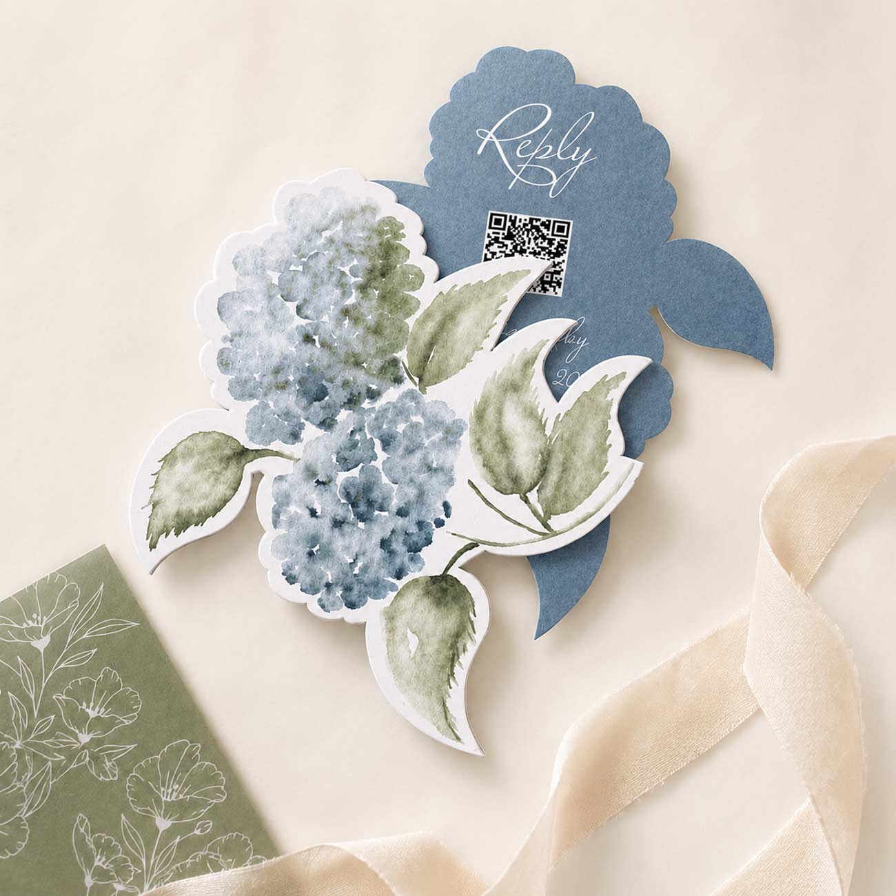 Die cut wedding invitations RSVP insert card with watercolor dusty blue hydrangeas, sage green leaves, and custom QR code reply card.