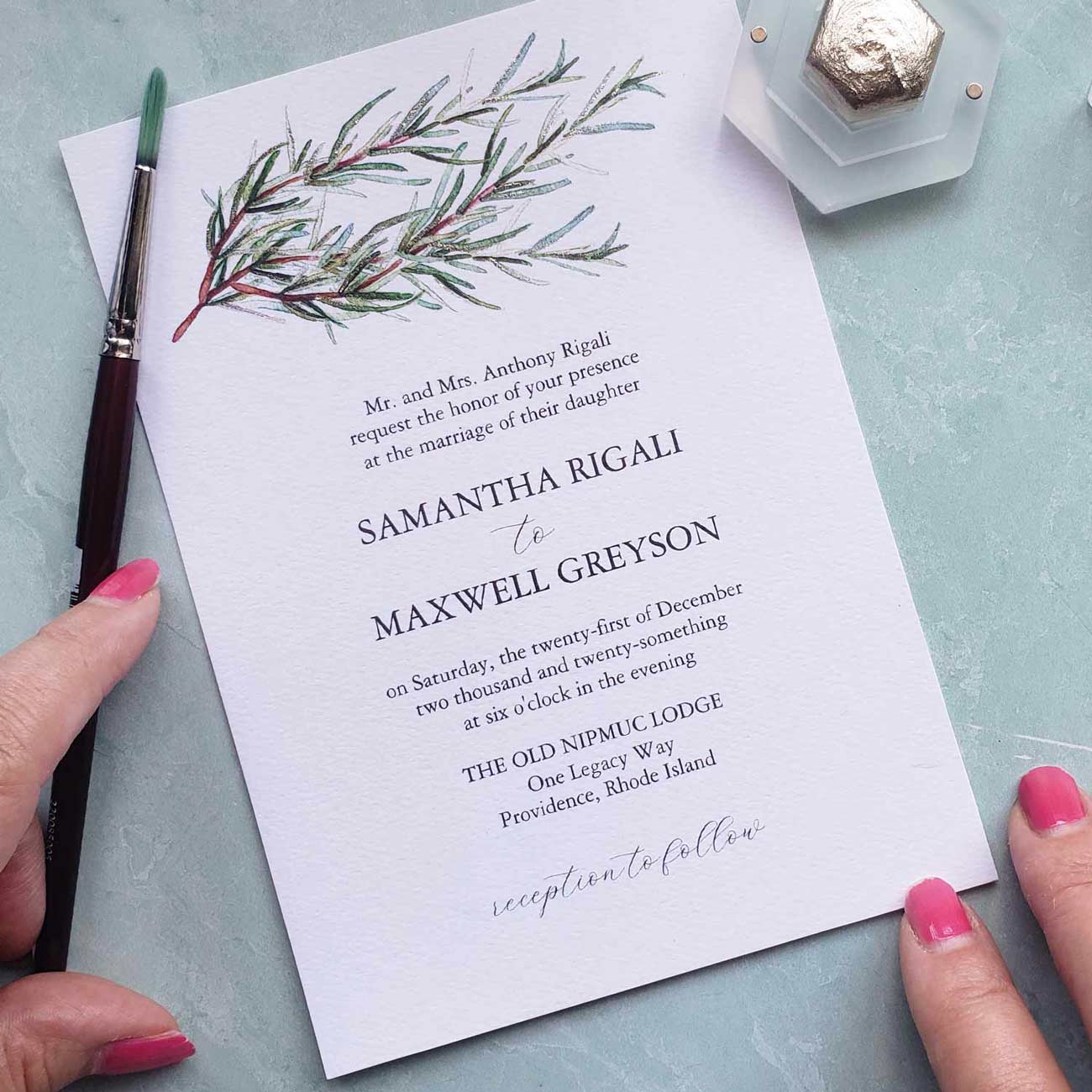Rustic wedding invitations featuring hand-painted watercolor pine boughs and nature-inspired wedding stationery.