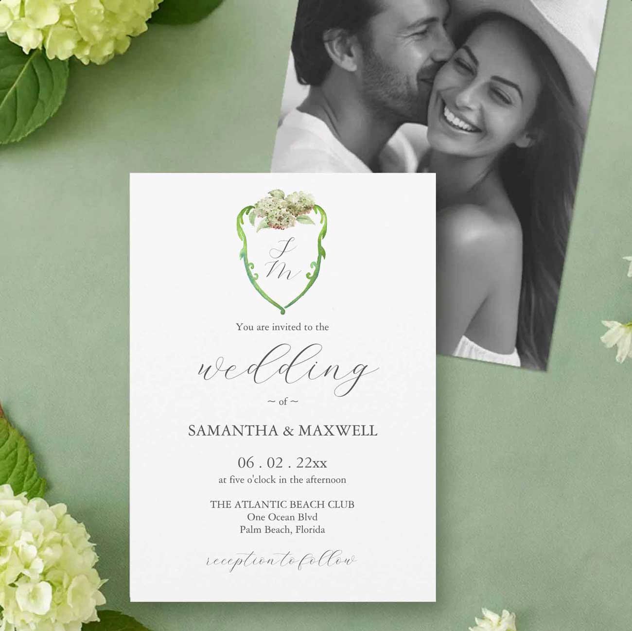 Custom watercolor crest wedding invitations featuring a green watercolor crest accented with hand-painted green hydrangea flowers and elegant wedding stationery.