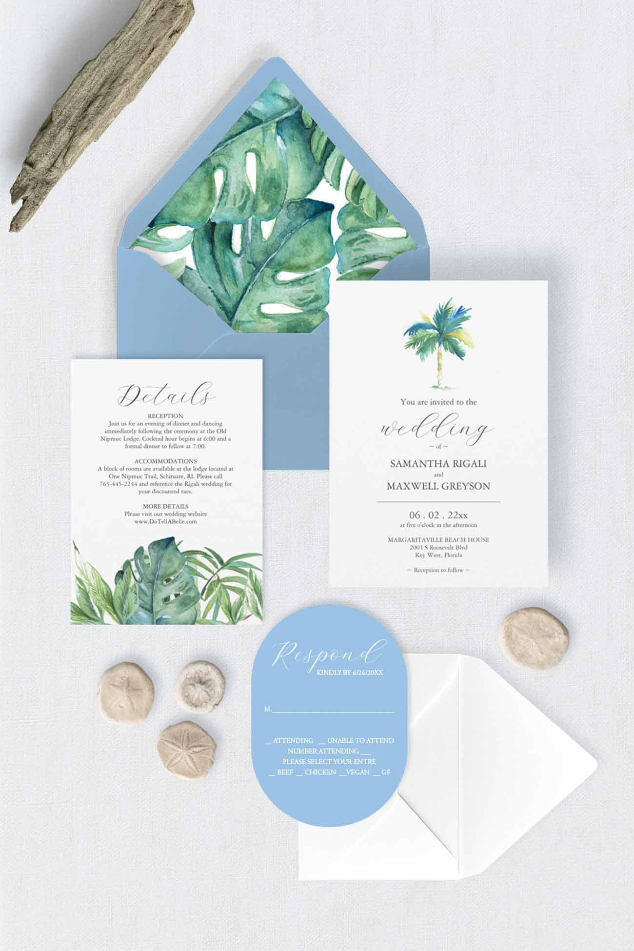 Destination wedding invitation suite featuring hand-painted watercolor palm trees, tropical palm leaves, a light blue RSVP card and envelope, and a monstera leaf envelope liner.