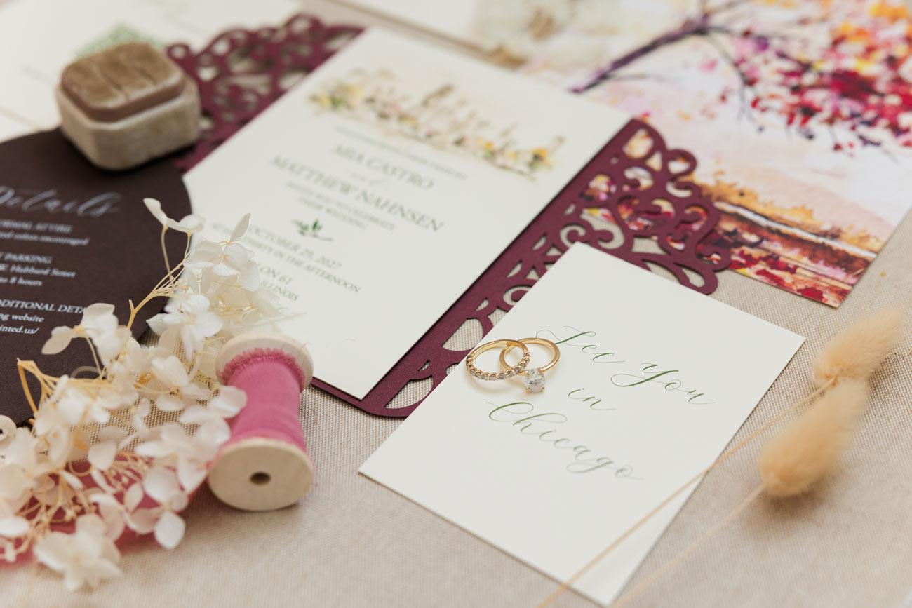 Watercolor Chicago skyline wedding invitation with burgundy laser-cut gate fold, fall watercolor envelope liner and coordinating details card.