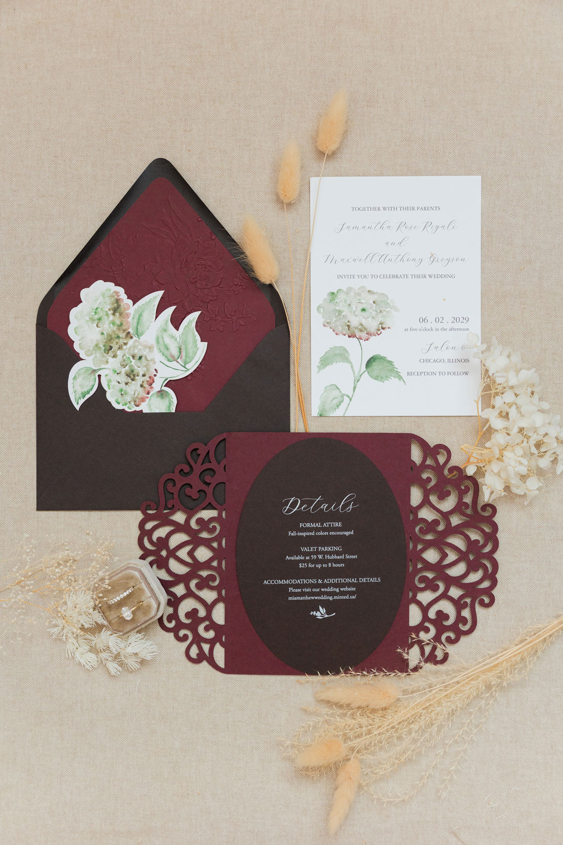 Hand-painted watercolor wedding invitation suite with hydrangeas, burgundy laser-cut details and coordinating envelope liner.