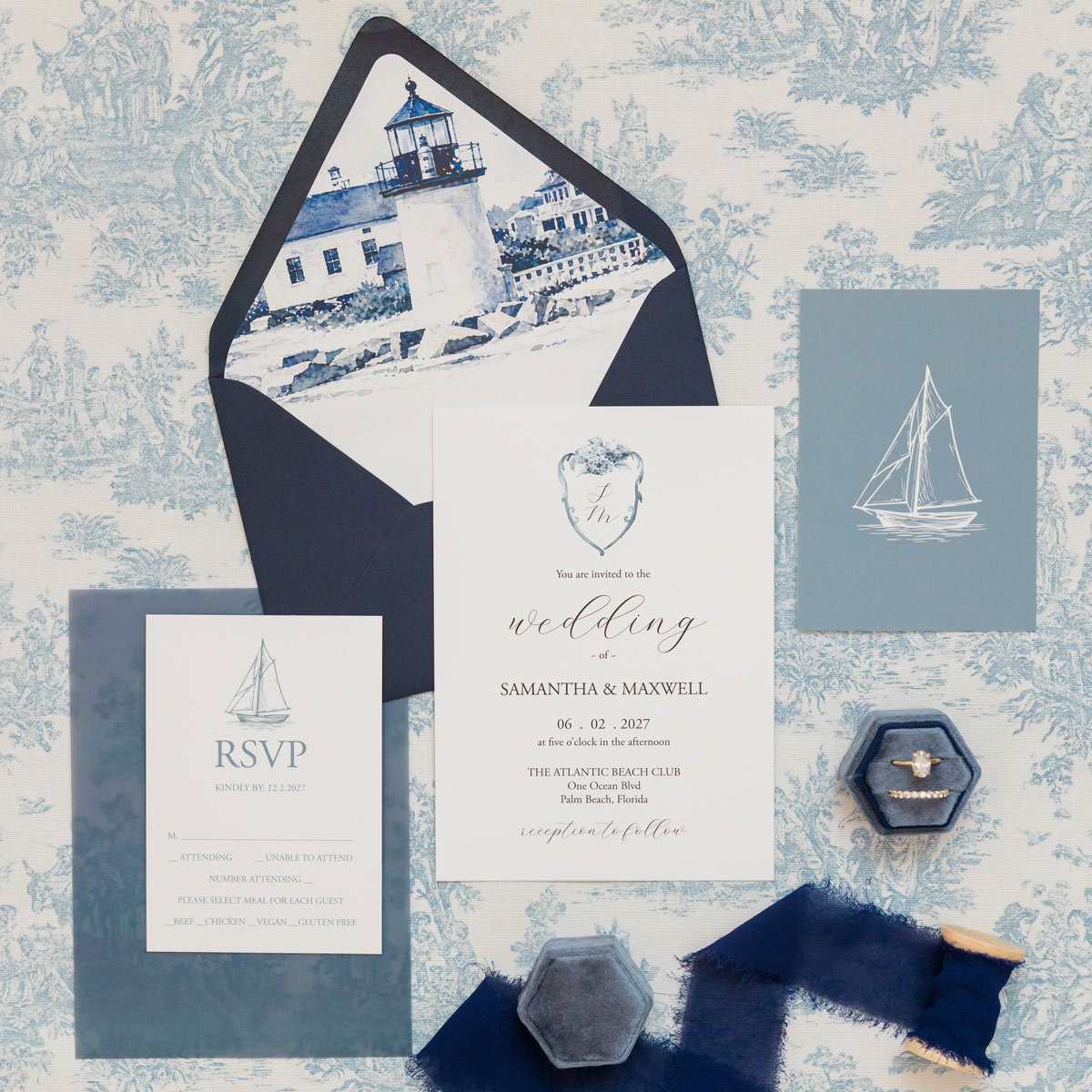 Nautical wedding invitation suite with watercolor Nantucket lighthouse envelope liner, sailboat RSVP card and dusty blue details.