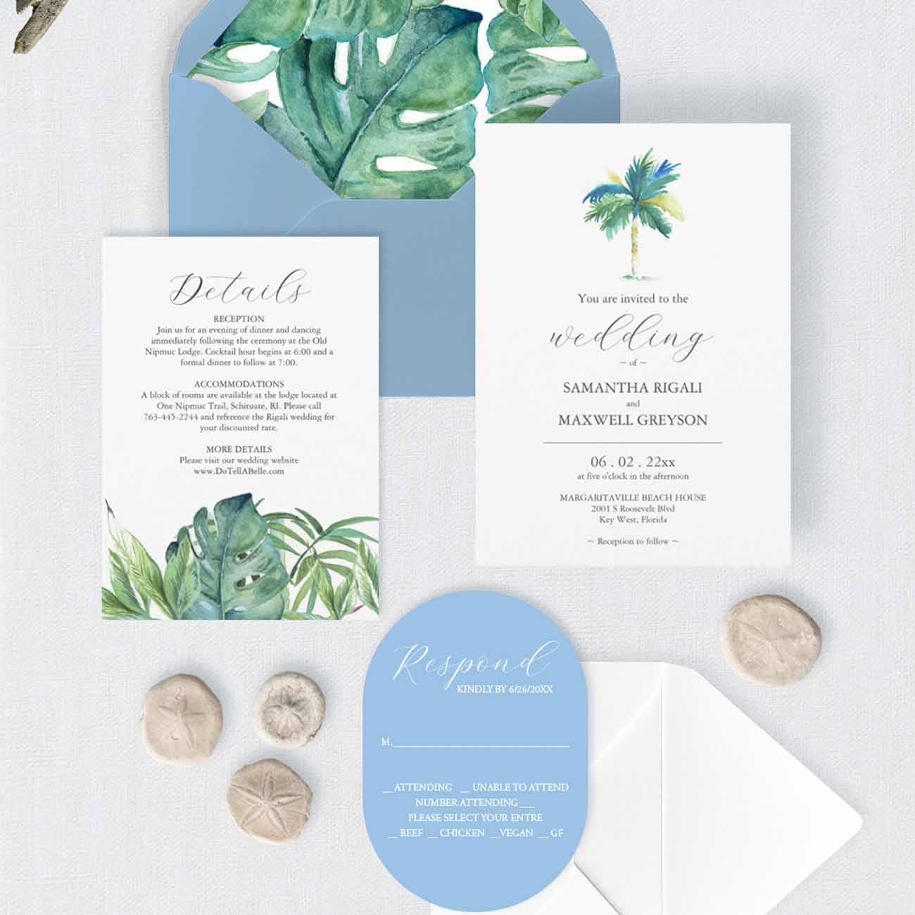 Blue watercolor wedding invitations with green palm tree and monstera leaves, blue die-cut RSVP card and coordinating blue envelope.