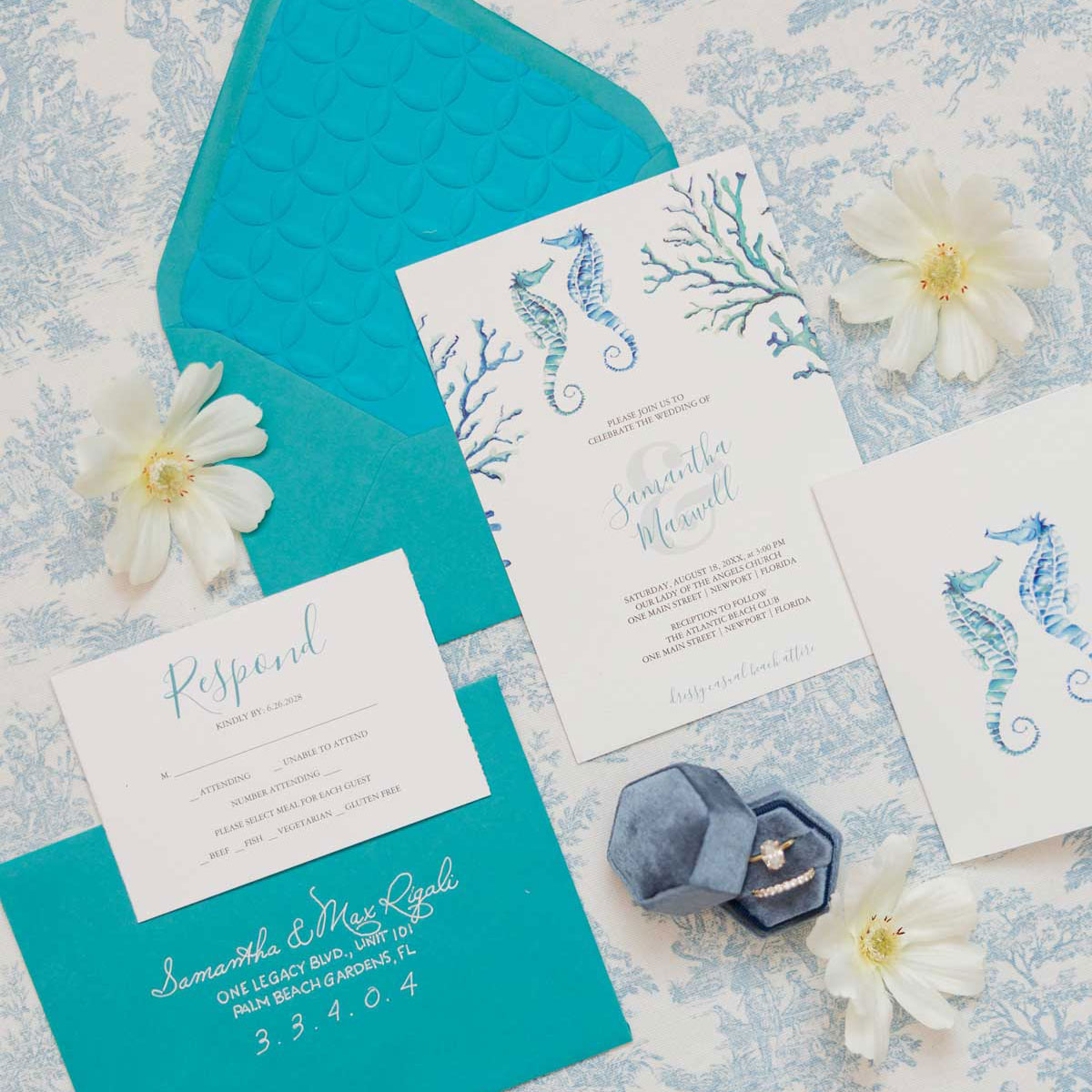 Watercolor beach wedding invitations with hand-painted seahorses and coral, turquoise envelope and embossed envelope liner.