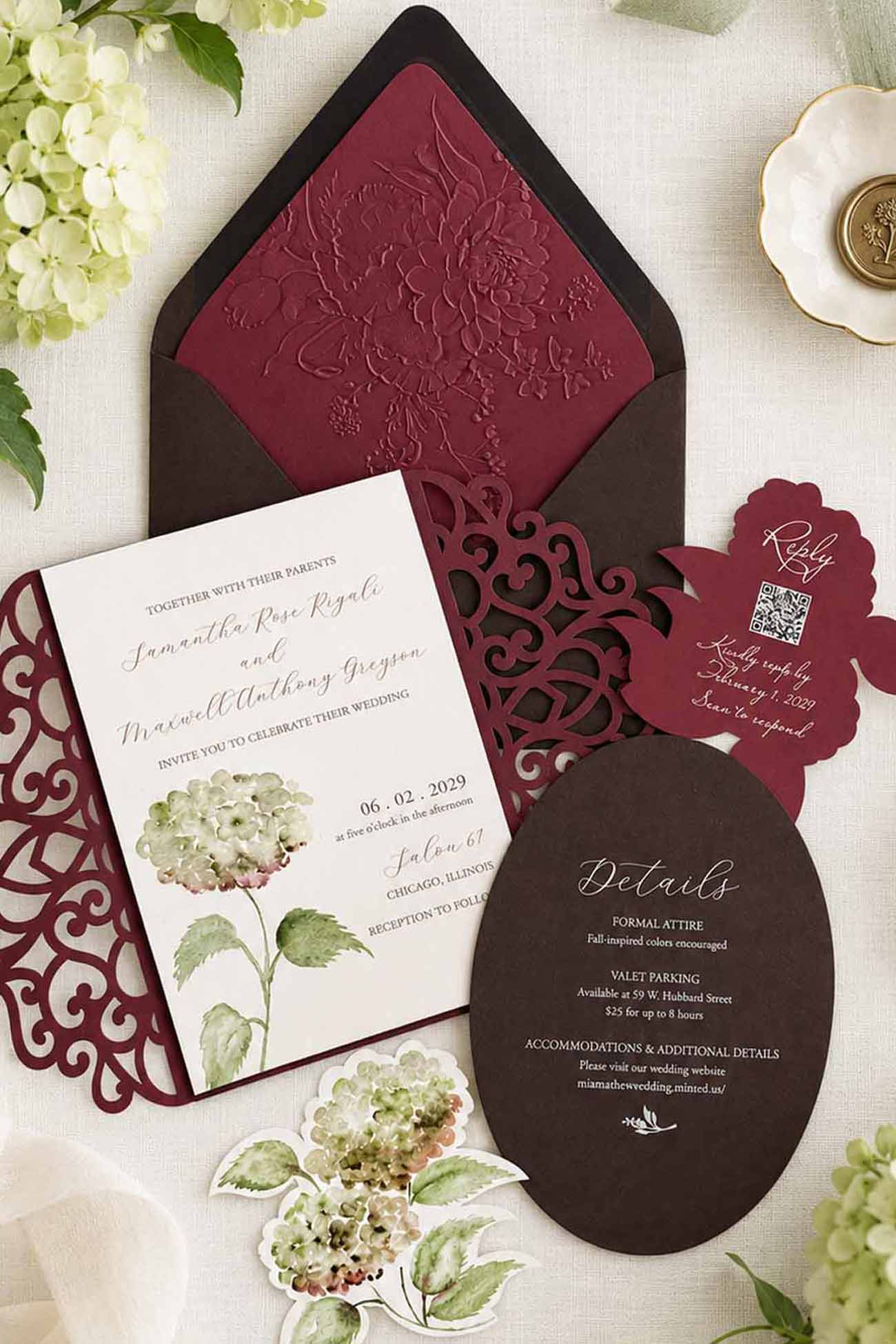 Watercolor wedding invitation suite featuring green and antique-toned hydrangeas, a burgundy laser-cut gatefold, embossed floral envelope liner, and coordinating die-cut floral inserts.